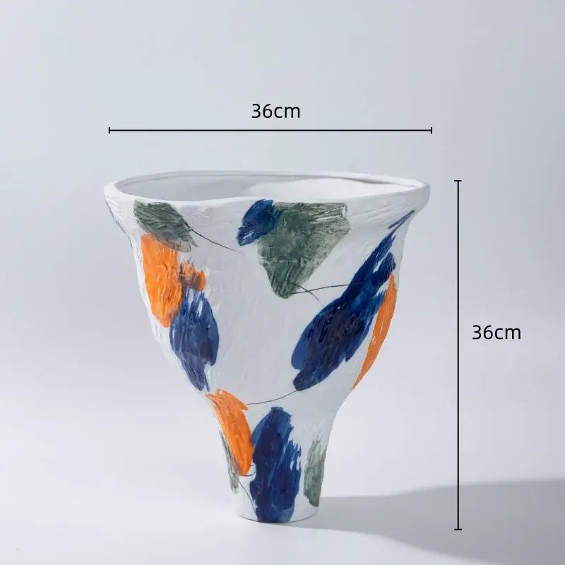 A white ceramic abstract irregular vase set with bold blue orange and green brushstroke patterns for living room decorbites decor
