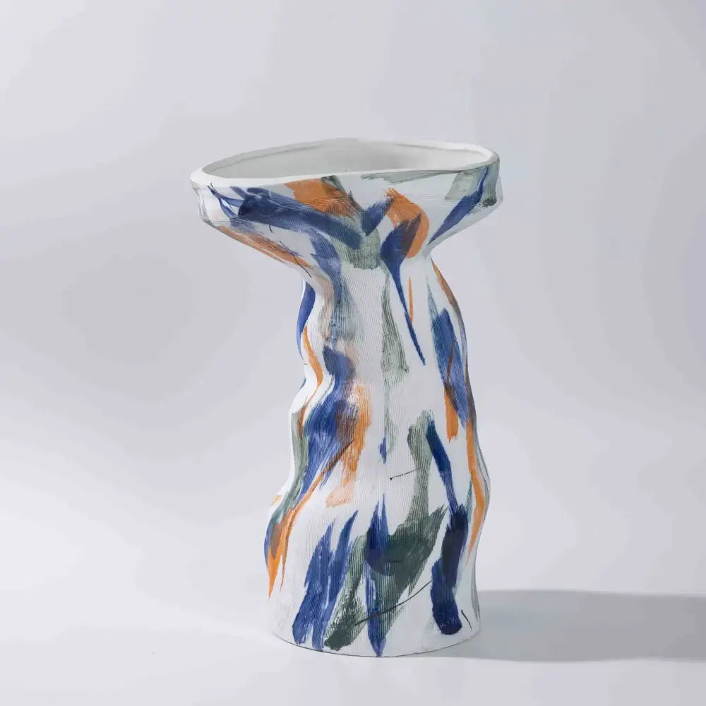 A white ceramic abstract irregular vase with flared top and bold blue orange green brushstrokes for decorbites vase set