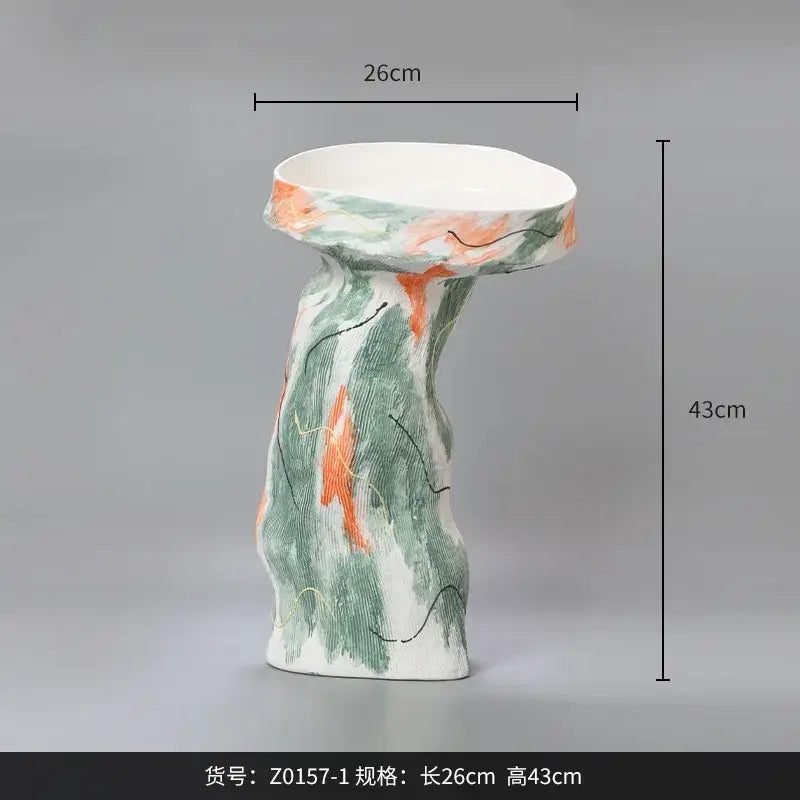 A tall ceramic pedestal vase with abstract irregular green and orange brushstroke pattern for living room decor