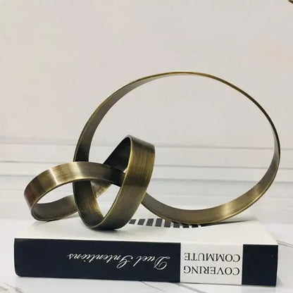 Antique brass-colored abstract knot golden metal sculpture with interlocking rings for living room decorbites decor