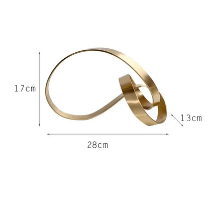 Gold-toned metallic abstract knot sculpture with intertwined loops for living room decor by decorbites abstract knot golden