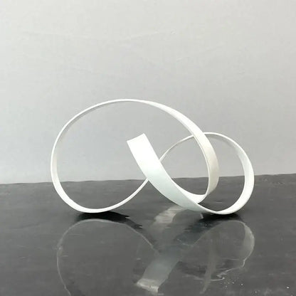 White minimalist abstract knot golden metal sculpture with smooth interlocking bands for living room decorbites abstract knot