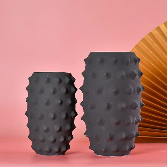 Two matte black ceramic sea urchin vases with textured spiky surface for decorbites black ceramic living room decor