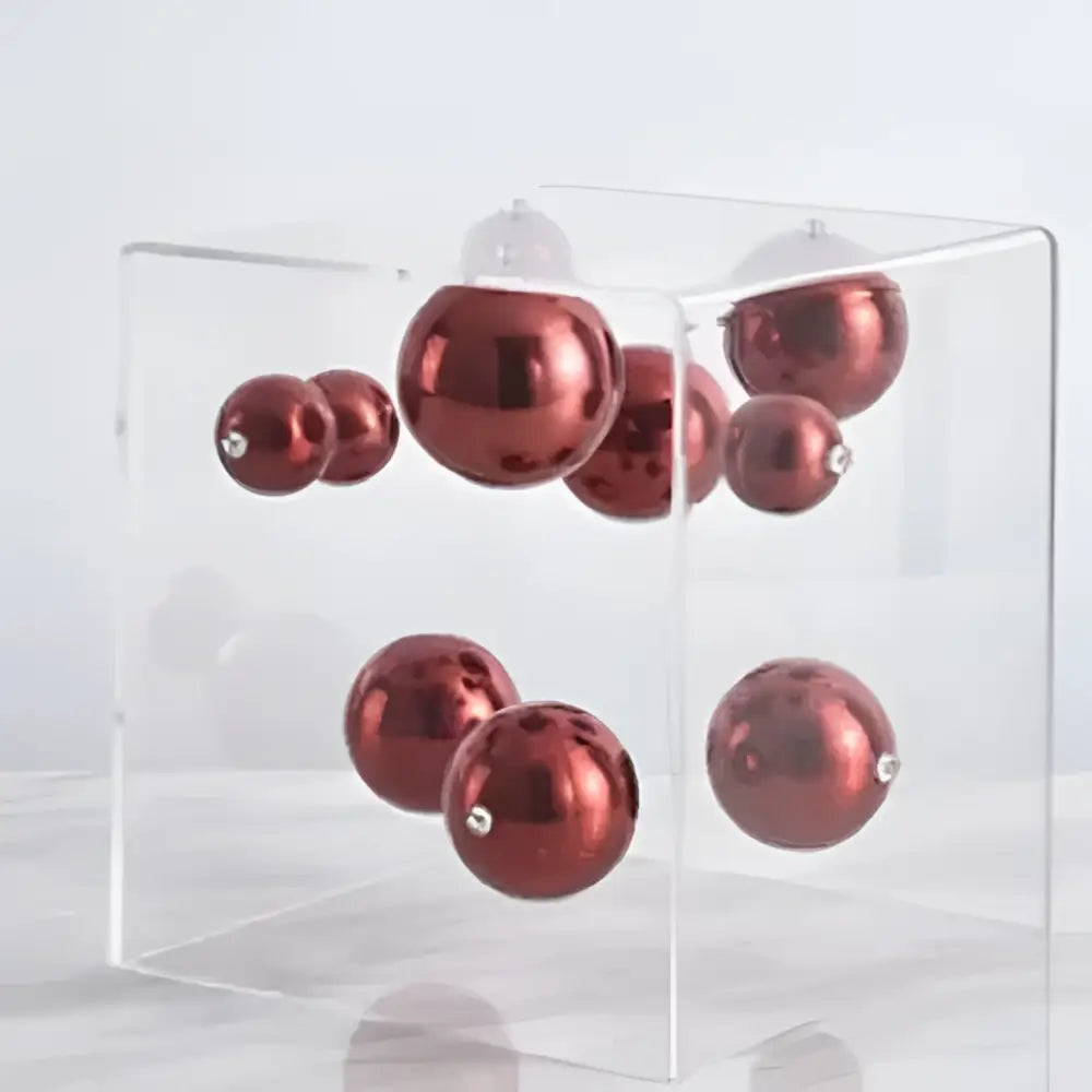 Clear acrylic cube holding shiny red ornaments showcasing decorbites abstract metal ball artworks for living room decor