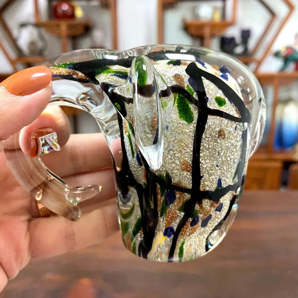 A translucent crystal glass sculpture mug with swirling black lines and green gold blue flecks for living room decorbites elephant crystal