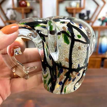 A translucent crystal glass sculpture mug with swirling black lines and green gold blue flecks for living room decorbites elephant crystal