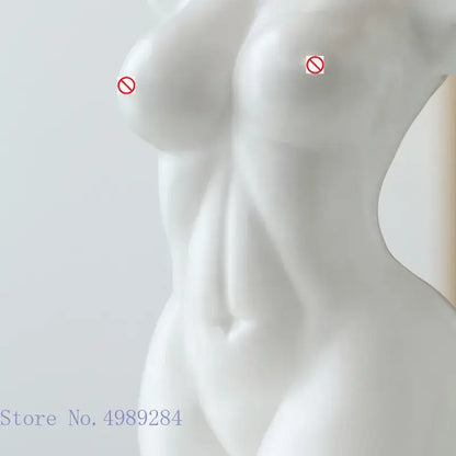 Abstract nude female white ceramic torso vase with smooth glossy finish and sculpted contours for living room decor