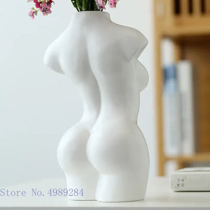 White ceramic vase shaped like an abstract nude female torso with smooth sculpted curves for living room decor