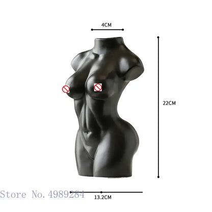 Black glossy resin abstract nude female torso sculpture with smooth curves and defined abs for living room decor
