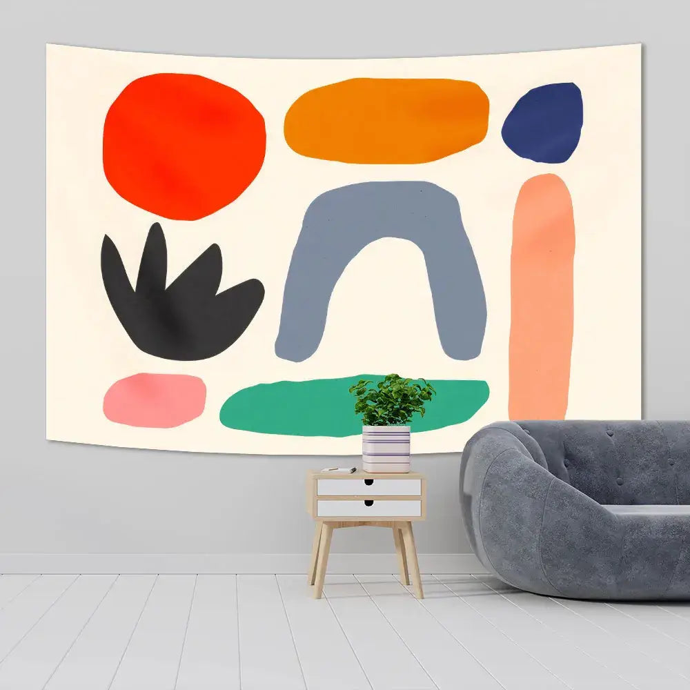 A modern abstract tapestry yoga mat with bold orange, navy, gray, coral pink, and green shapes on cream background