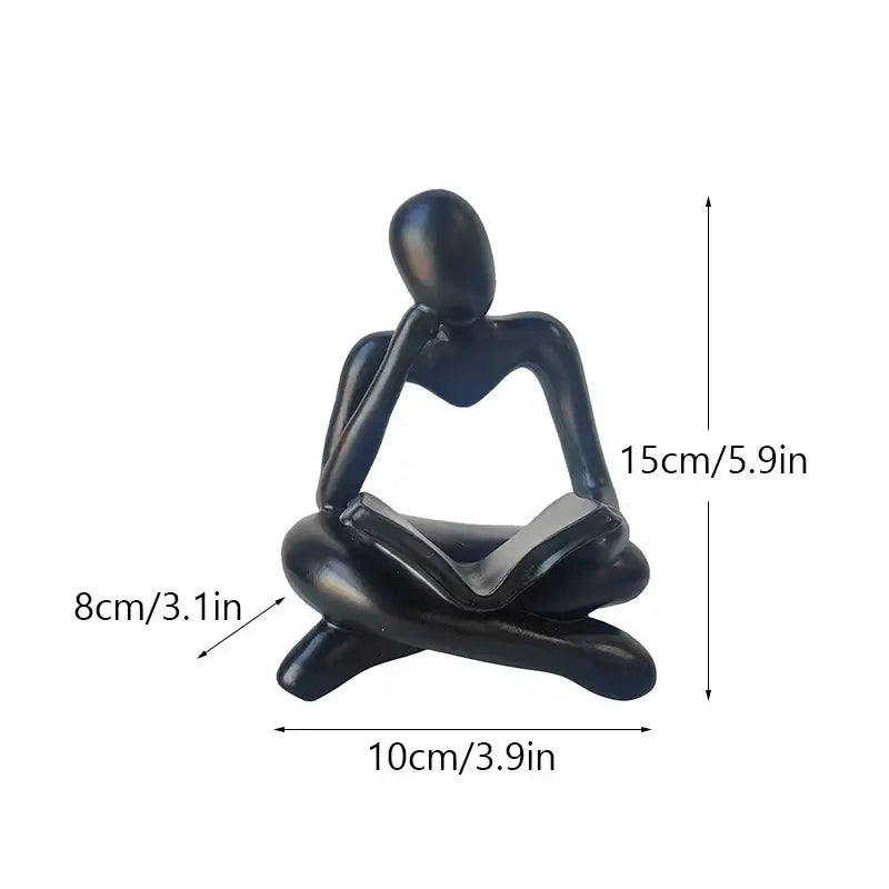 Black glossy resin book figurine of a seated thinker holding an open book for decorbites abstract resin office decor
