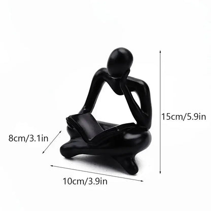 Black glossy resin book figurine of a seated thinker with hands on chin in decorbites abstract resin office decor