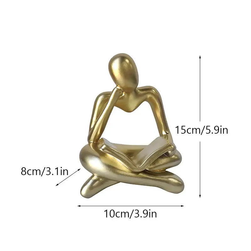 Golden metallic resin book figurine of a seated figure reading for abstract resin book decorbites office decorbites abstract resin