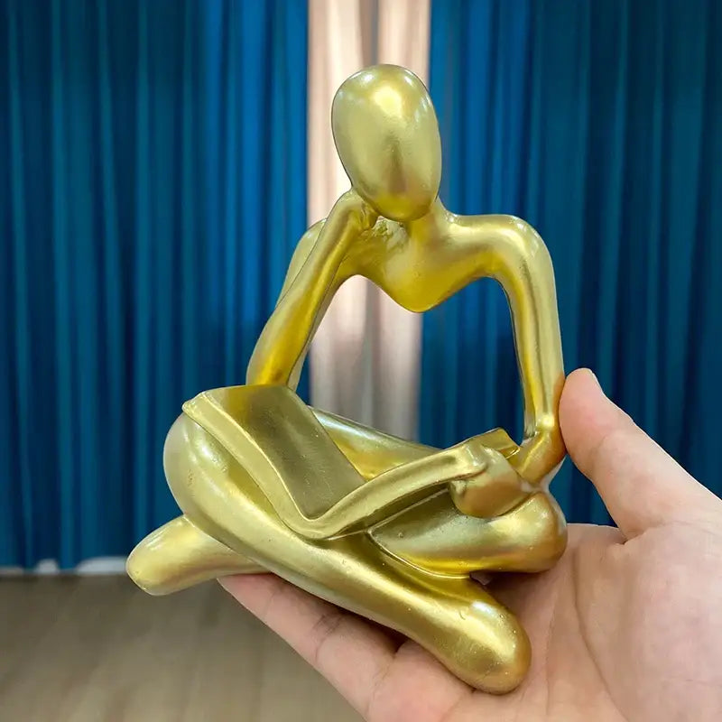 Golden glossy decorbites abstract resin book figurine with smooth curves for black and white office decor