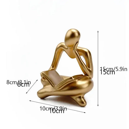Golden metallic resin book figurine of a seated thinker holding a book for decorbites abstract resin office decorbites abstract resin