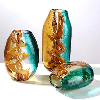 Three hand-blown abstract ripple glass vases with swirling amber and teal hues for decorbites abstract ripple decor