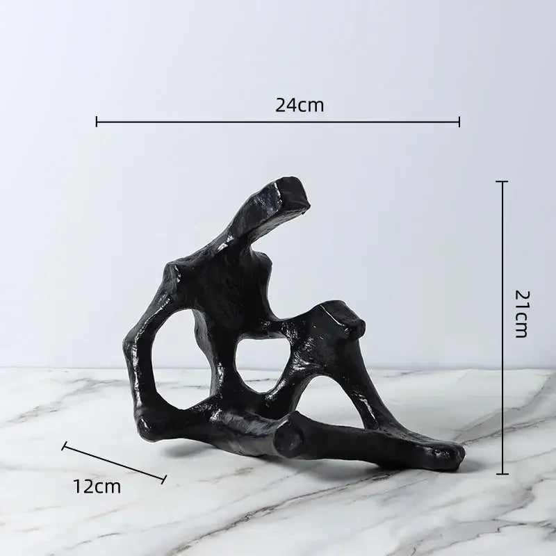 Black abstract skeleton decor figure sculpture with branching glossy finish used as living room bookends