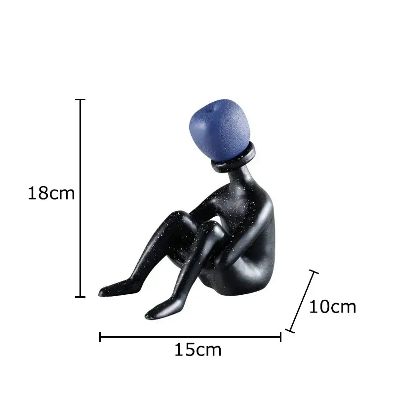Black resin abstract thinker figurine with a textured blue apple head for living room decor by decorbites abstract thinker