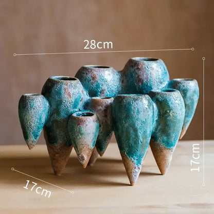 A cluster of teal and brown ceramic decorbites abstract tooth hanging vases with textured speckled glaze for living room decor