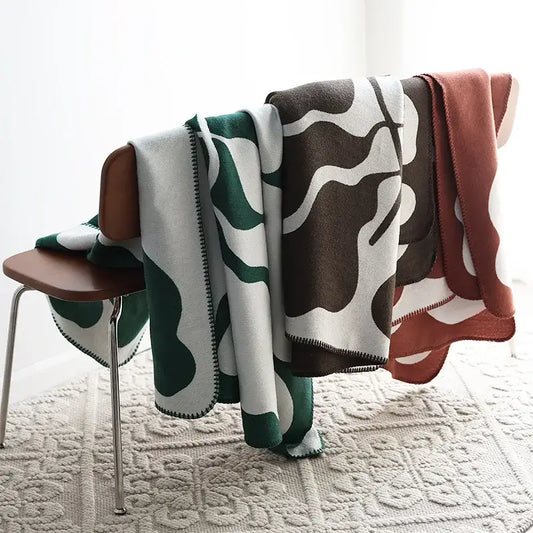 Three cozy jacquard imitation cashmere throw blankets with abstract wavy patterns in green, brown, and rust decorbites jacquard imitation