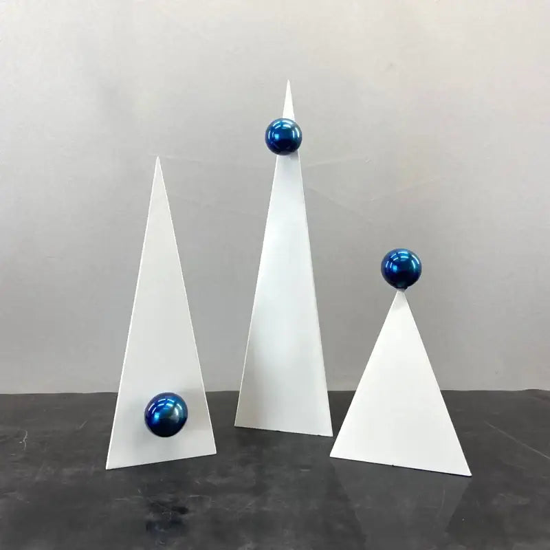 Set of three abstract white geometric triangle decor bites ornaments topped with glossy blue spheres for living room decor