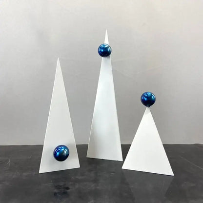 Set of three abstract white geometric triangle decor bites ornaments topped with glossy blue spheres for living room decor