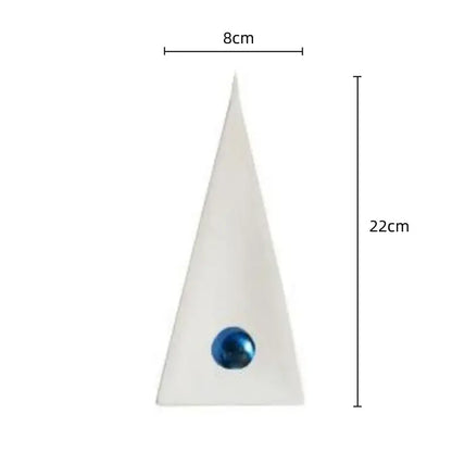 A sleek white geometric triangle decorbites ornament with a glossy blue spherical accent for living room decor