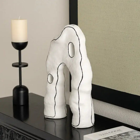 Abstract white and black geometric ceramic vase by decorbites features white ceramic with black outlined shapes and two circular cutouts