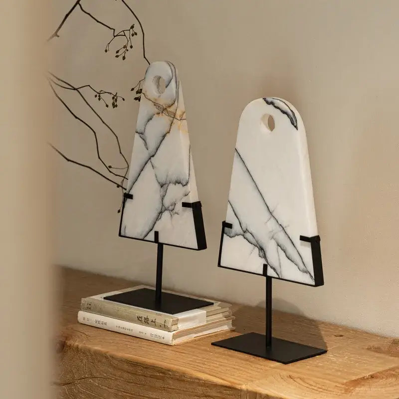 Two elegant white marble sculpture bookends with gray veining on black metal stands for abstract jade pendant decorbites decor