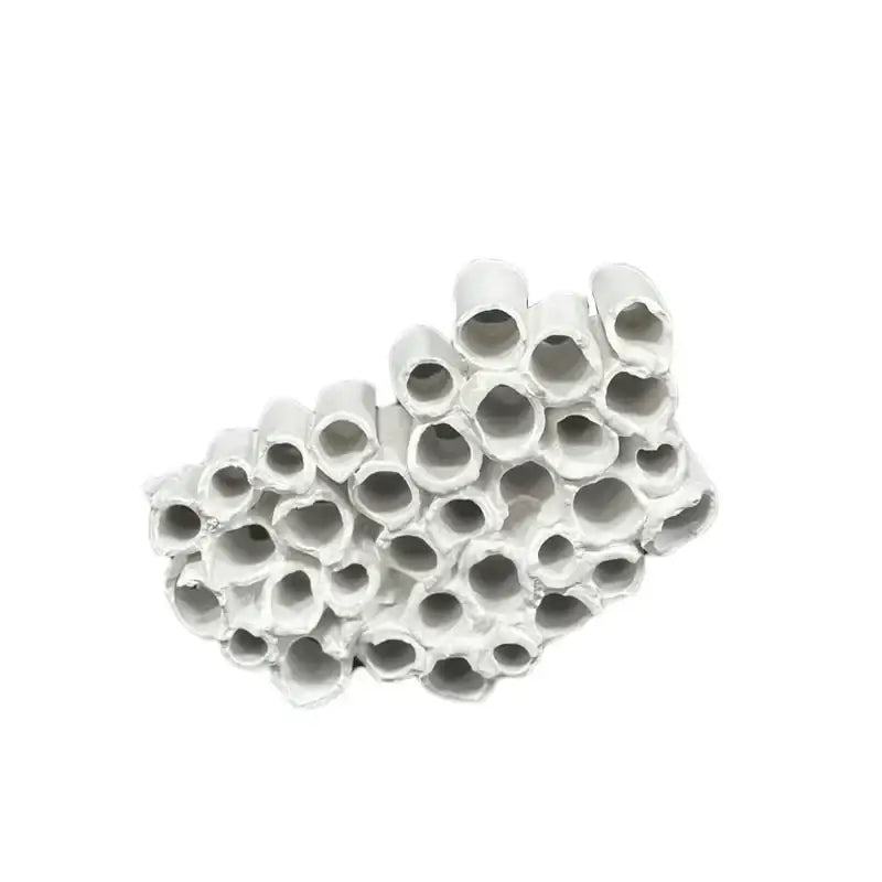 Abstract white ceramic insect hotel featuring honeycomb mesh conduit design with cylindrical tubes for living room decor