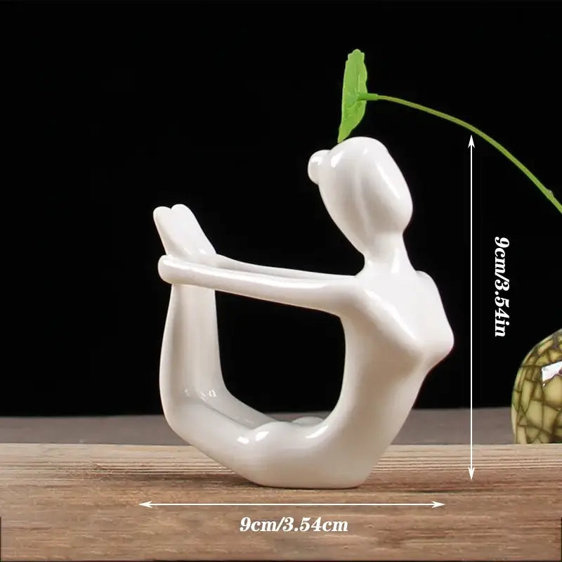 Abstract white porcelain yoga figure with green leafy stem for living room decorbites abstract yoga decor
