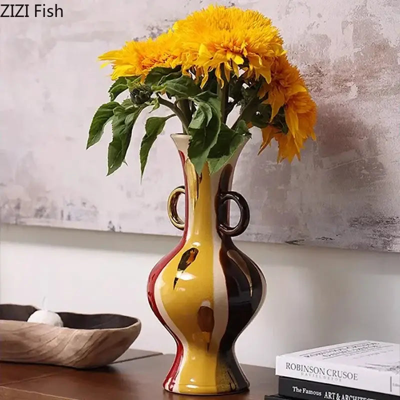 Glossy ceramic vase plant with vibrant yellow red and black abstract design and gold toned ring handles for living room decor
