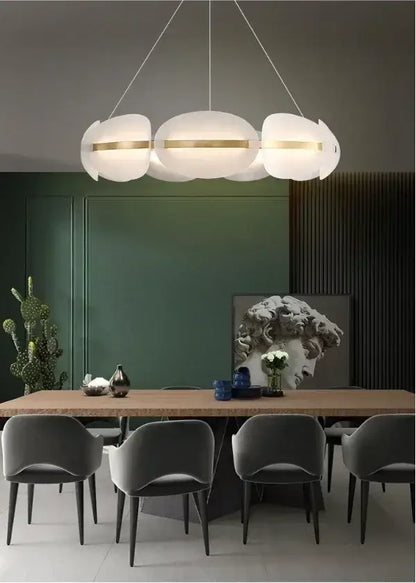 Modern dimmable pendant light with three white cloud-shaped shades accented by gold bands acrylic ring chandelier