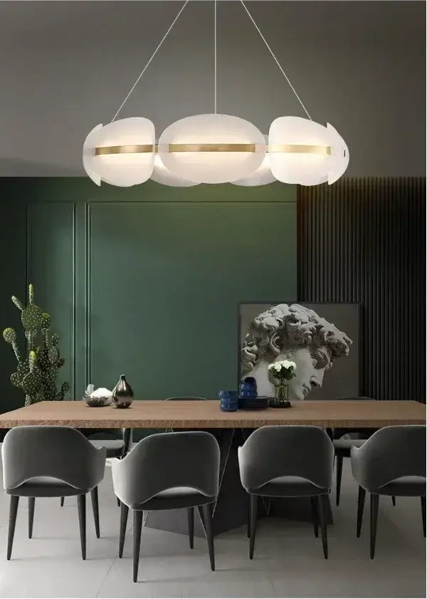 Modern dimmable pendant light with three white cloud-shaped shades accented by gold bands acrylic ring chandelier