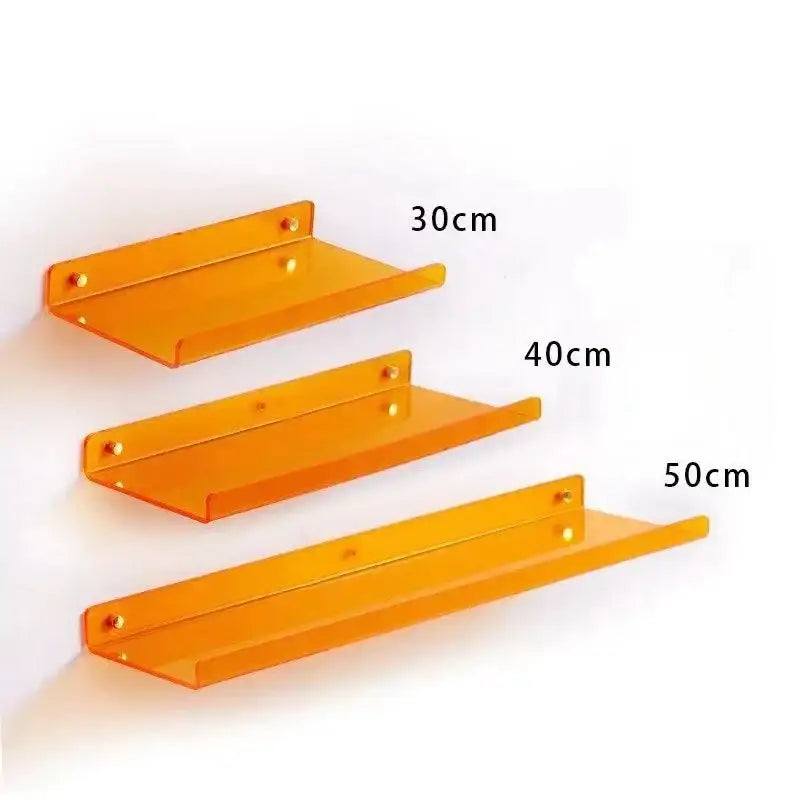 Set of three translucent orange acrylic wall shelves in varying lengths for home decor and wall shelf organizer use