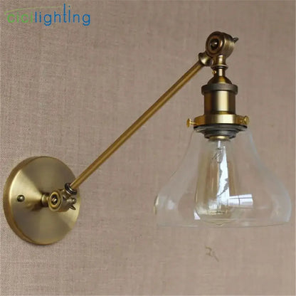 Adjustable brass wall sconce with clear glass dome and exposed filament bulb for bedroom wall lamp decorbites brass copper