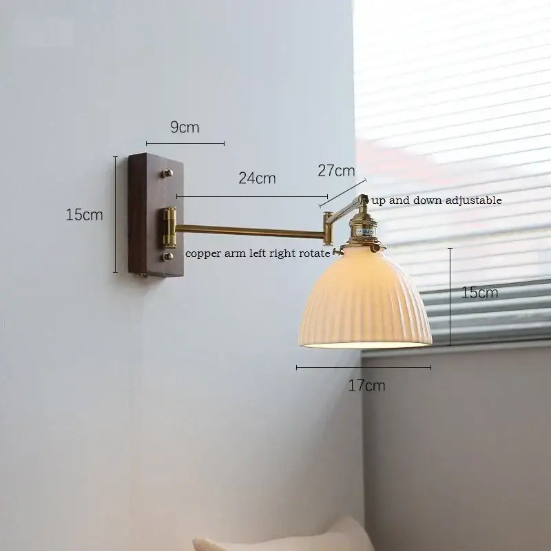 Adjustable brass wall sconce with copper arm and ribbed off-white glass shade for bedroom lighting decorbites copper arm