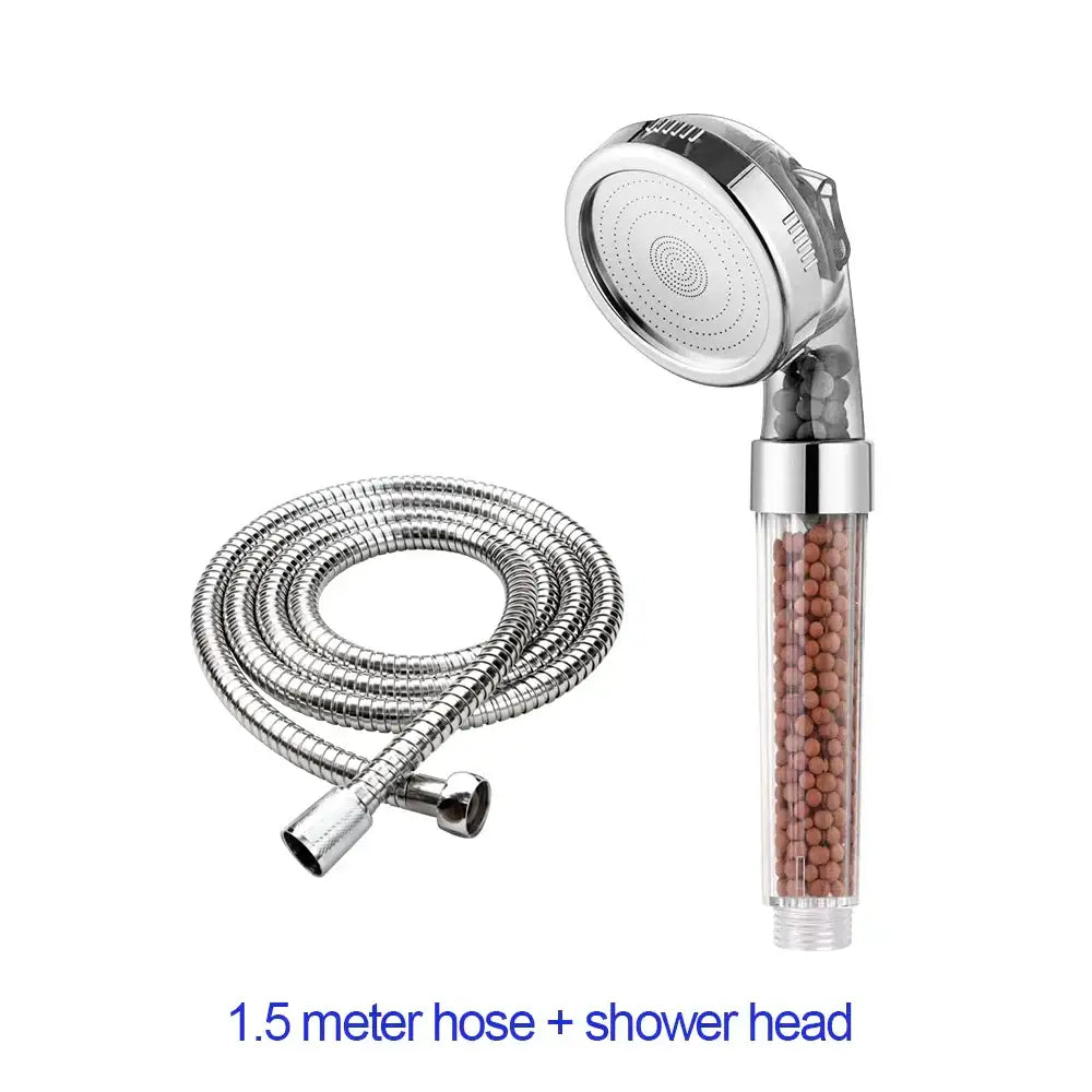 Adjustable high pressure silver shower head with transparent cylindrical body containing brown filter beads and chrome hose