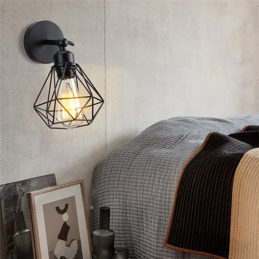 Black metal wall light with adjustable industrial vintage iron cage and exposed filament bulb for bedroom decorbites style