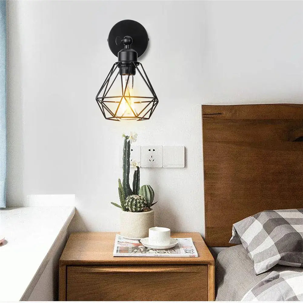 Black geometric cage-style wall light with exposed filament bulb decorbites adjustable industrial vintage design