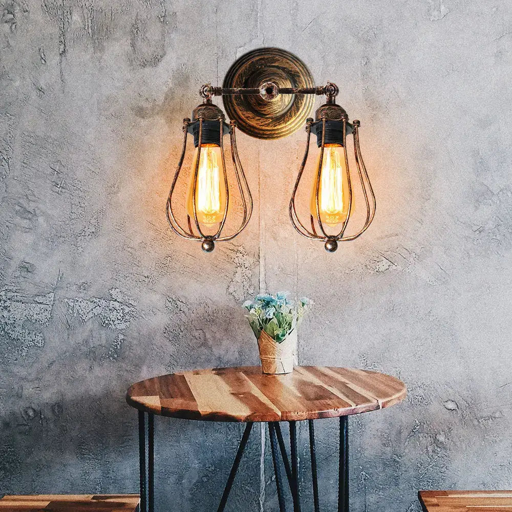 Adjustable industrial wall light in bronze with vintage-style brass sconces and wrought iron cages for bedroom and hallway decorbites