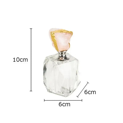 A clear faceted glass agate stone perfume bottle with a pink rose quartz stopper for essential oils bedroom decor