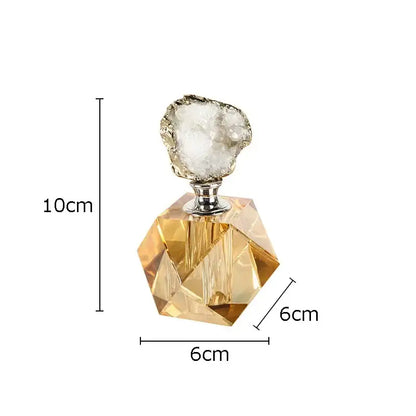 A faceted amber glass agate stone perfume bottle with silver metal neck and white geode stopper for essential oils
