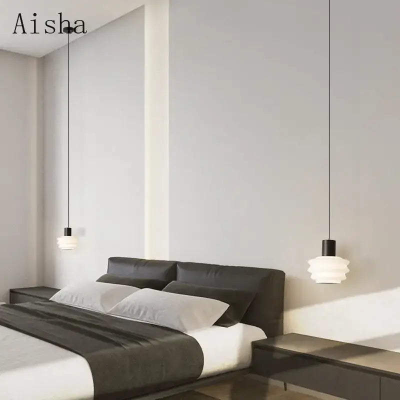 Modern white layered pendant light with black fixtures featuring decorbites acrylic led hanging above a sleek bed