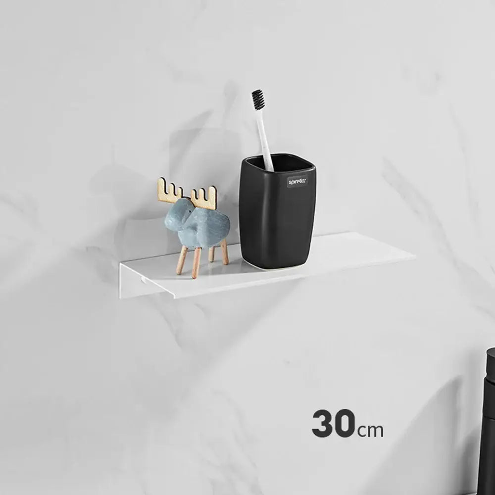 Black ceramic toothbrush holder with sparebox branding on aluminum floating shelves using nail free glue for bathroom use