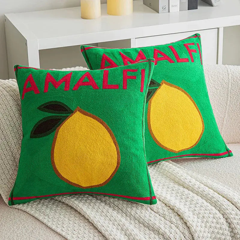 Green embroidered cushion cover featuring a yellow lemon with green leaves and red amalfi lettering for living room use