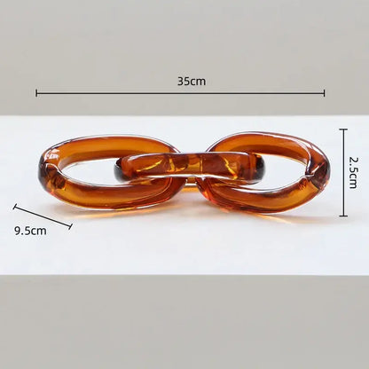 Translucent amber-colored acrylic chain buckle with glossy finish and interlocking oval design for decorbites glass handcrafted decor