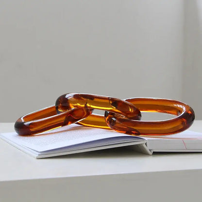 Translucent amber-colored acrylic glass handcrafted chain buckles with a glossy smooth finish for living room decor
