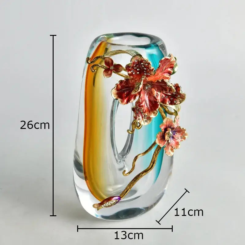 A translucent amber and blue gradient glass vase with red and gold floral relief and rhinestones for living room decor