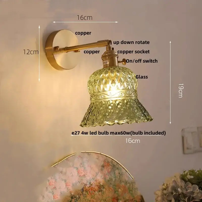 Antique brass wall light fixture with amber textured glass shade and scalloped rim for bedroom pull chain use